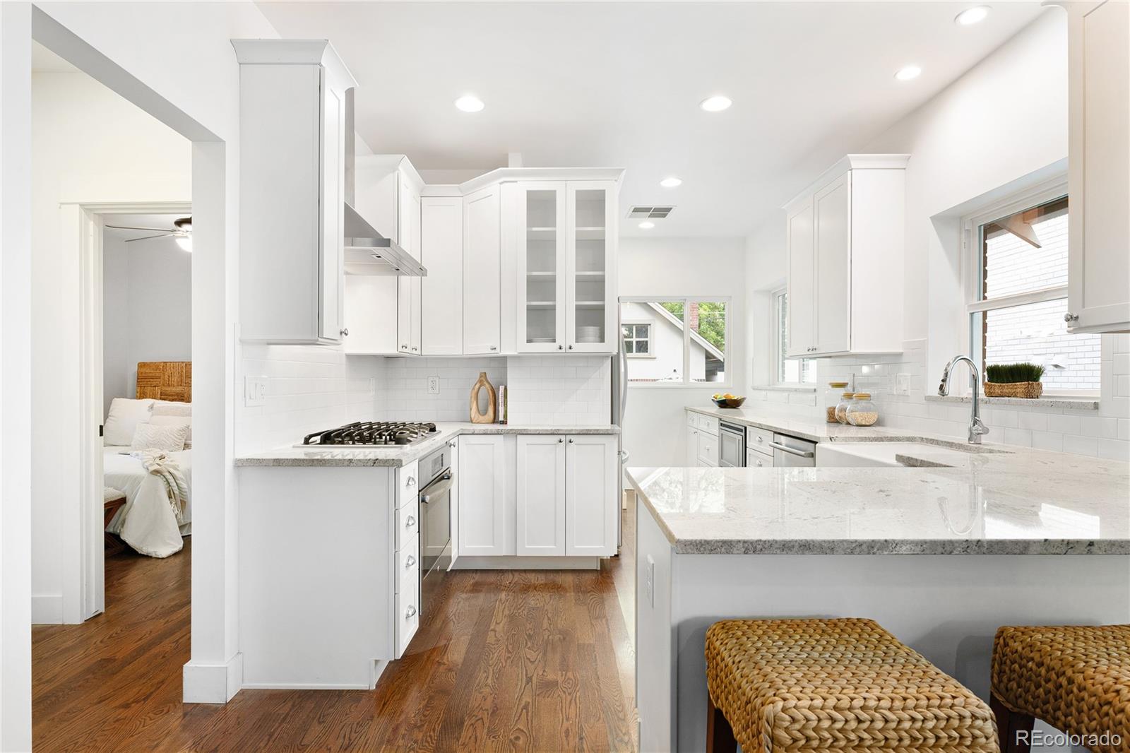 486 South Corona Street Denver, CO 80209 - Photo 13 of 46 a kitchen with granite countertop white cabinets and appliances