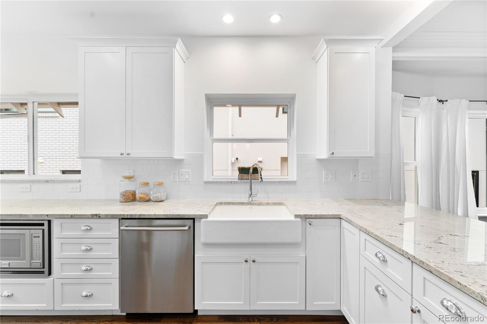 486 South Corona Street Denver, CO 80209 - Photo 16 of 46 a kitchen with cabinets appliances a sink and a window