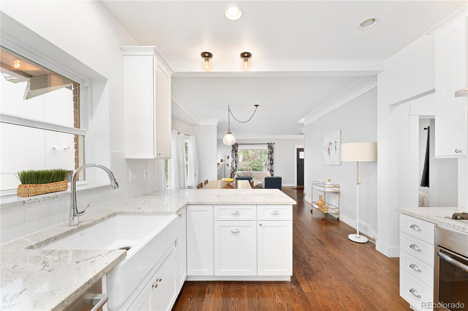 486 South Corona Street Denver, CO 80209 - Photo 17 of 46 a large kitchen with a lot of counter space and wooden floor