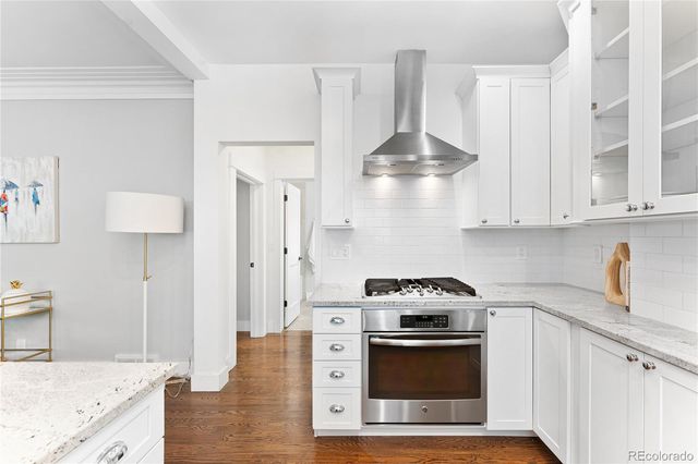 a kitchen with stainless steel appliances a stove a sink and a refrigerator