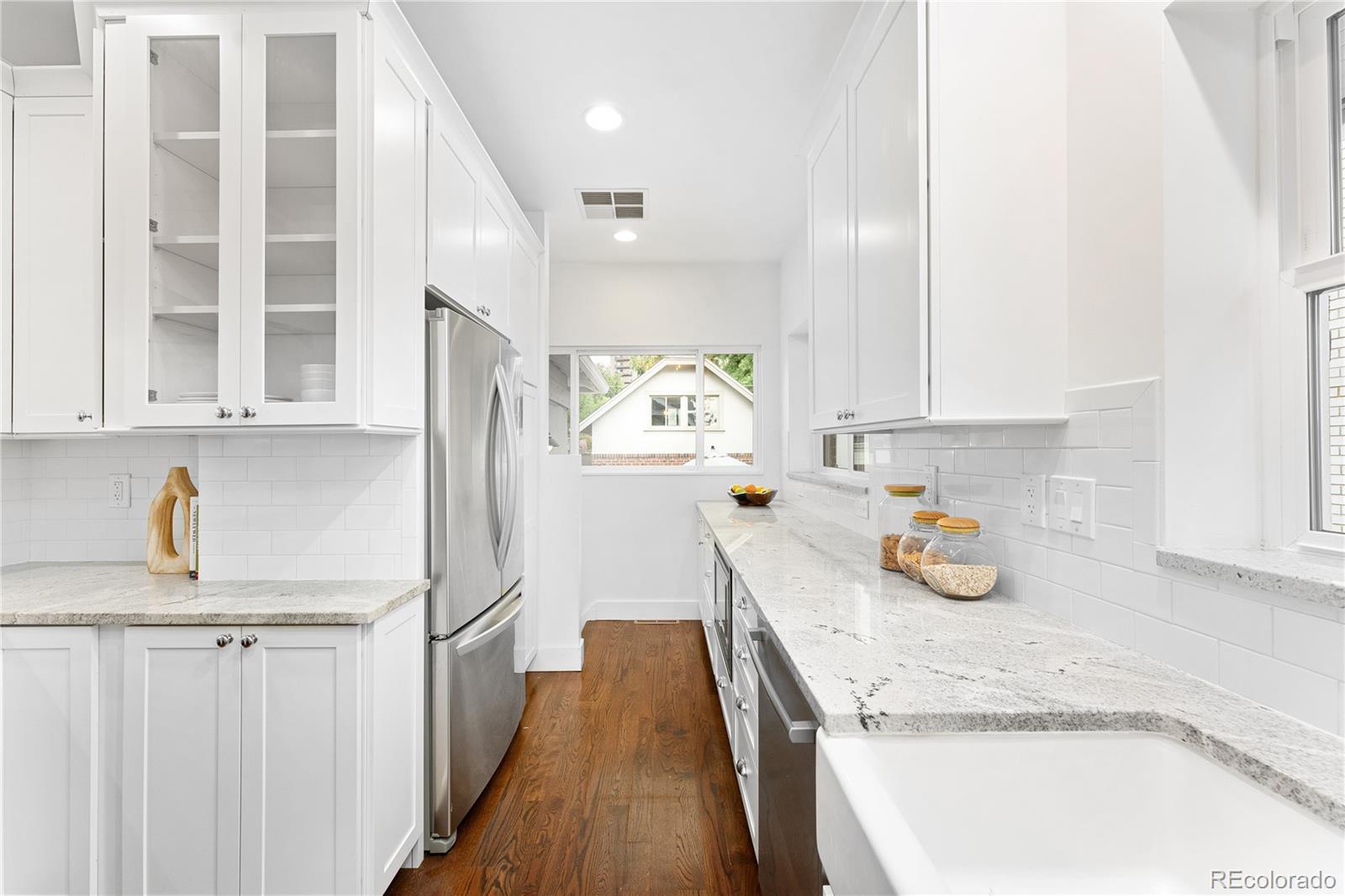 486 South Corona Street Denver, CO 80209 - Photo 19 of 46 a kitchen with sink cabinets and window