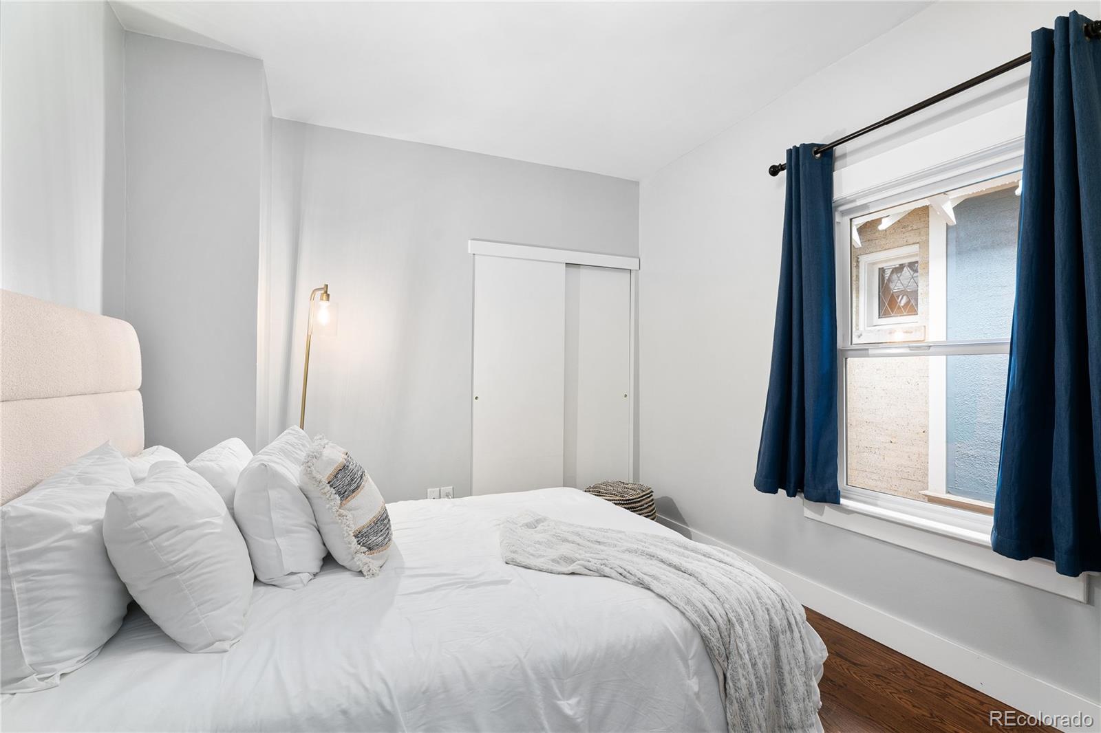 486 South Corona Street Denver, CO 80209 - Photo 22 of 46 a bedroom with a bed and a window