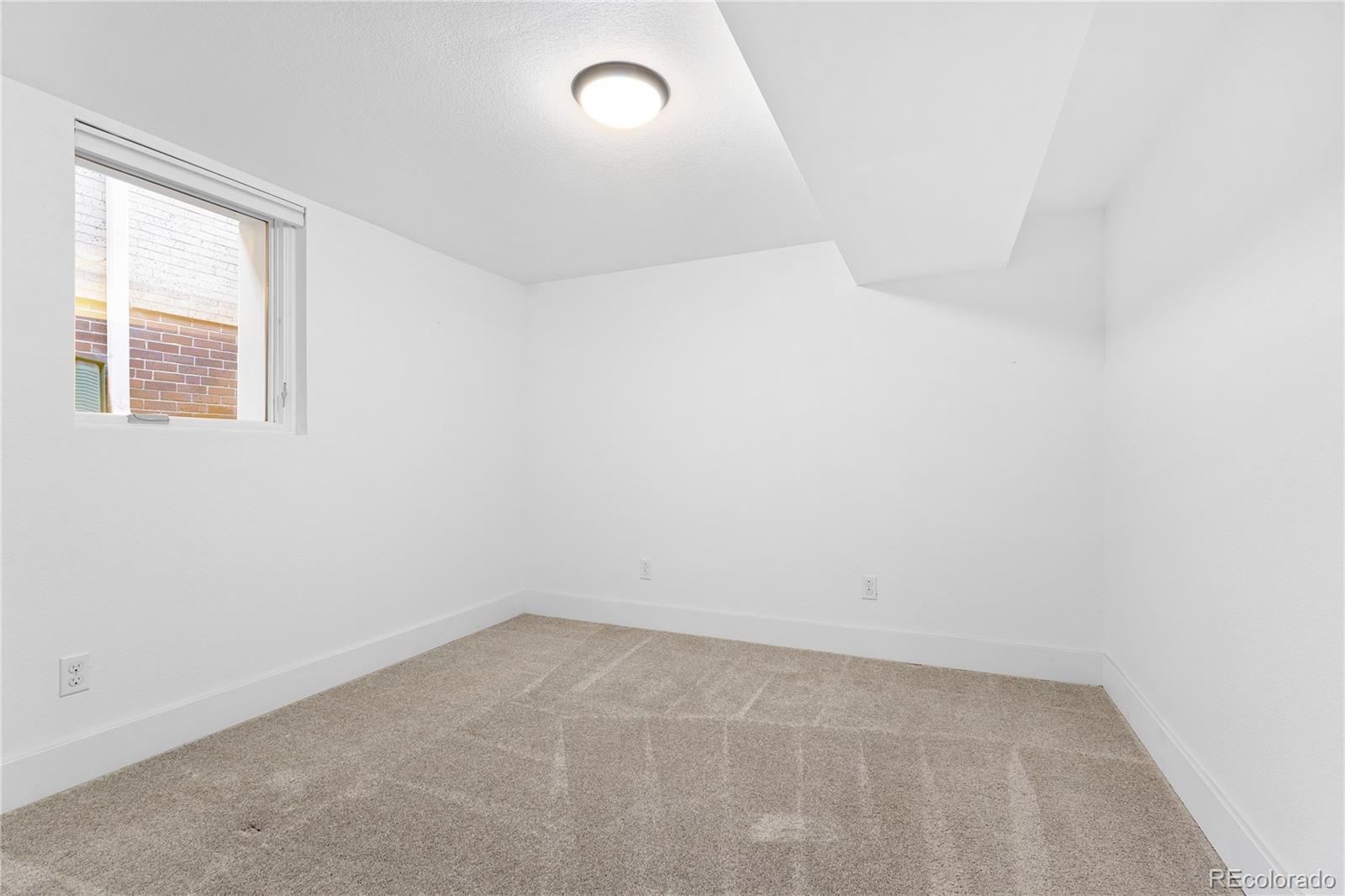 486 South Corona Street Denver, CO 80209 - Photo 29 of 46 an empty room with a window