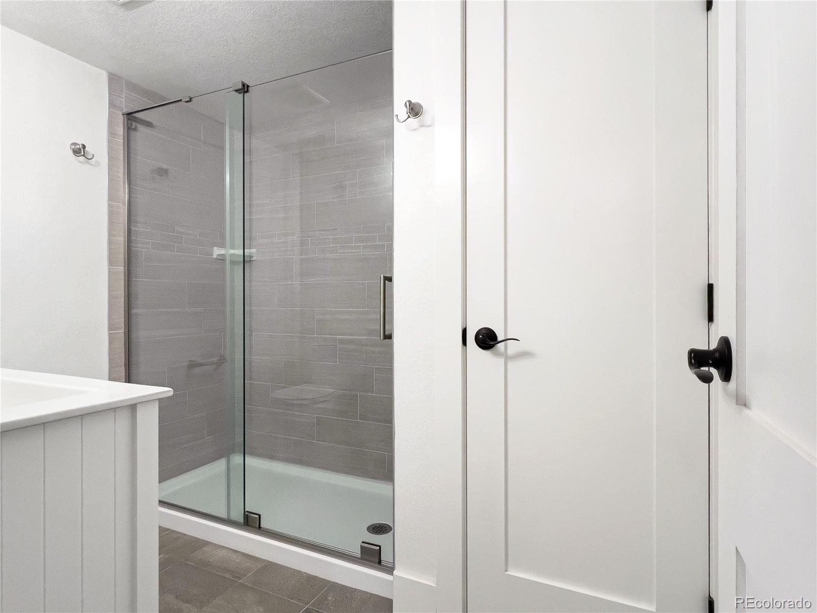 486 South Corona Street Denver, CO 80209 - Photo 31 of 46 a bathroom with a shower and a sink