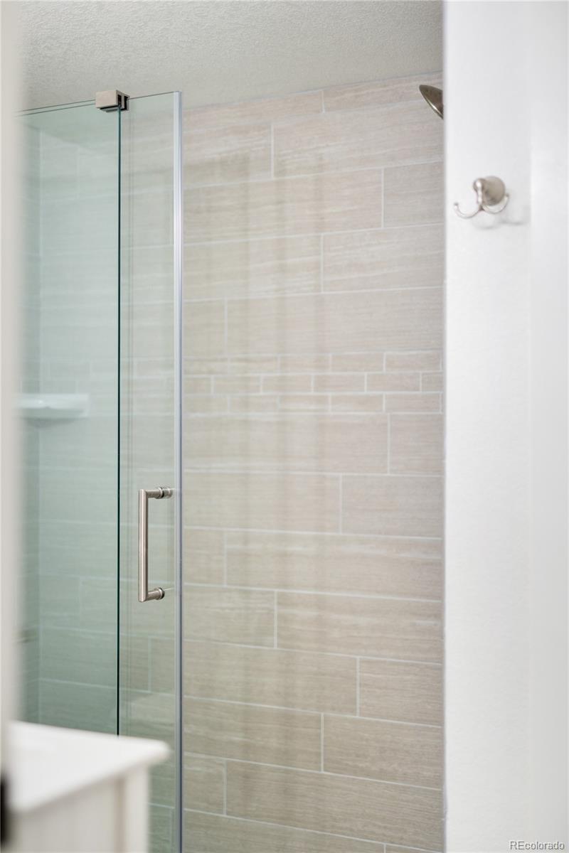 486 South Corona Street Denver, CO 80209 - Photo 32 of 46 a bathroom with a shower and a toilet