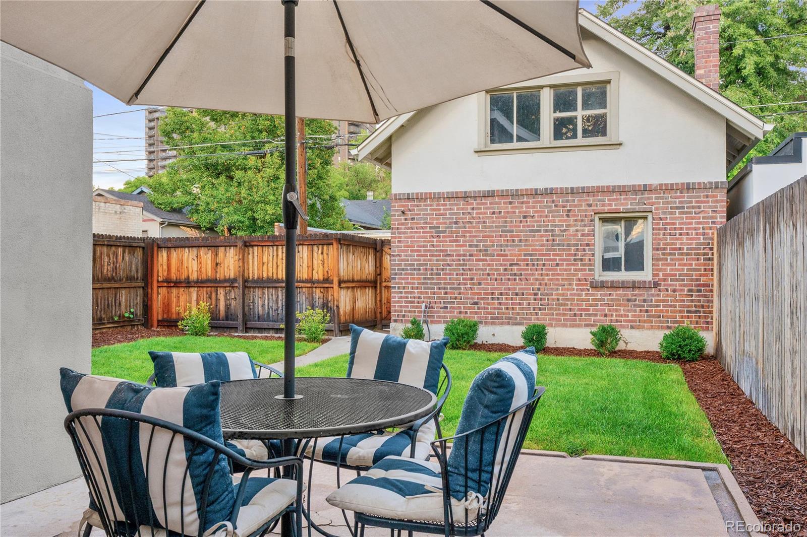 486 South Corona Street Denver, CO 80209 - Photo 33 of 46 a backyard of a house with a garden and barbeque oven