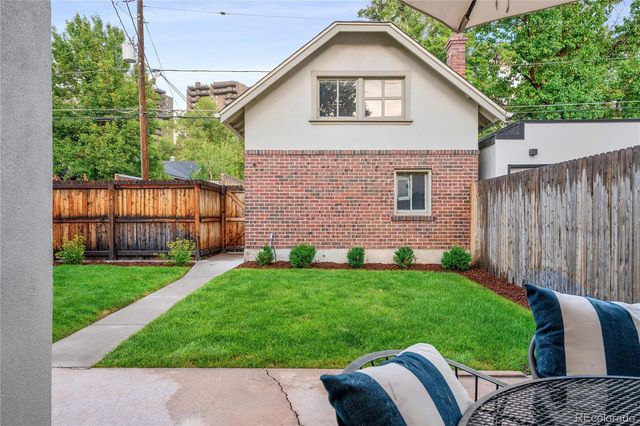 a view of a house with a yard and sitting area