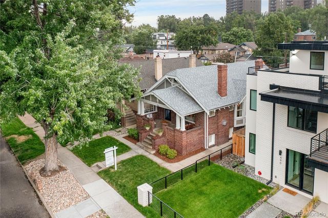 an aerial view of residential houses with outdoor space and street view