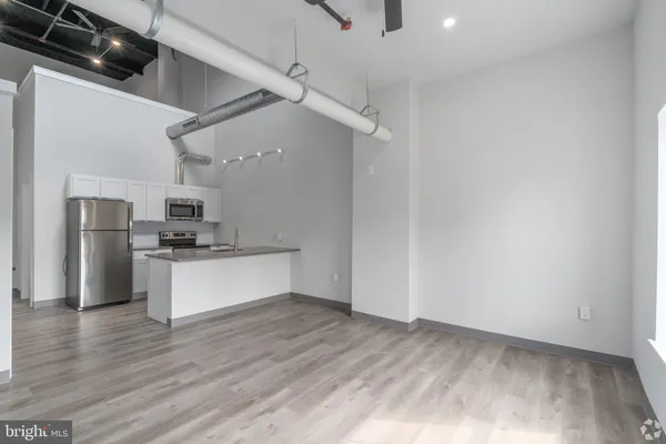 a kitchen with stainless steel appliances a refrigerator and a stove top oven