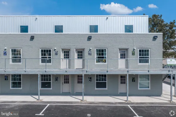 a front view of a house with a parking space
