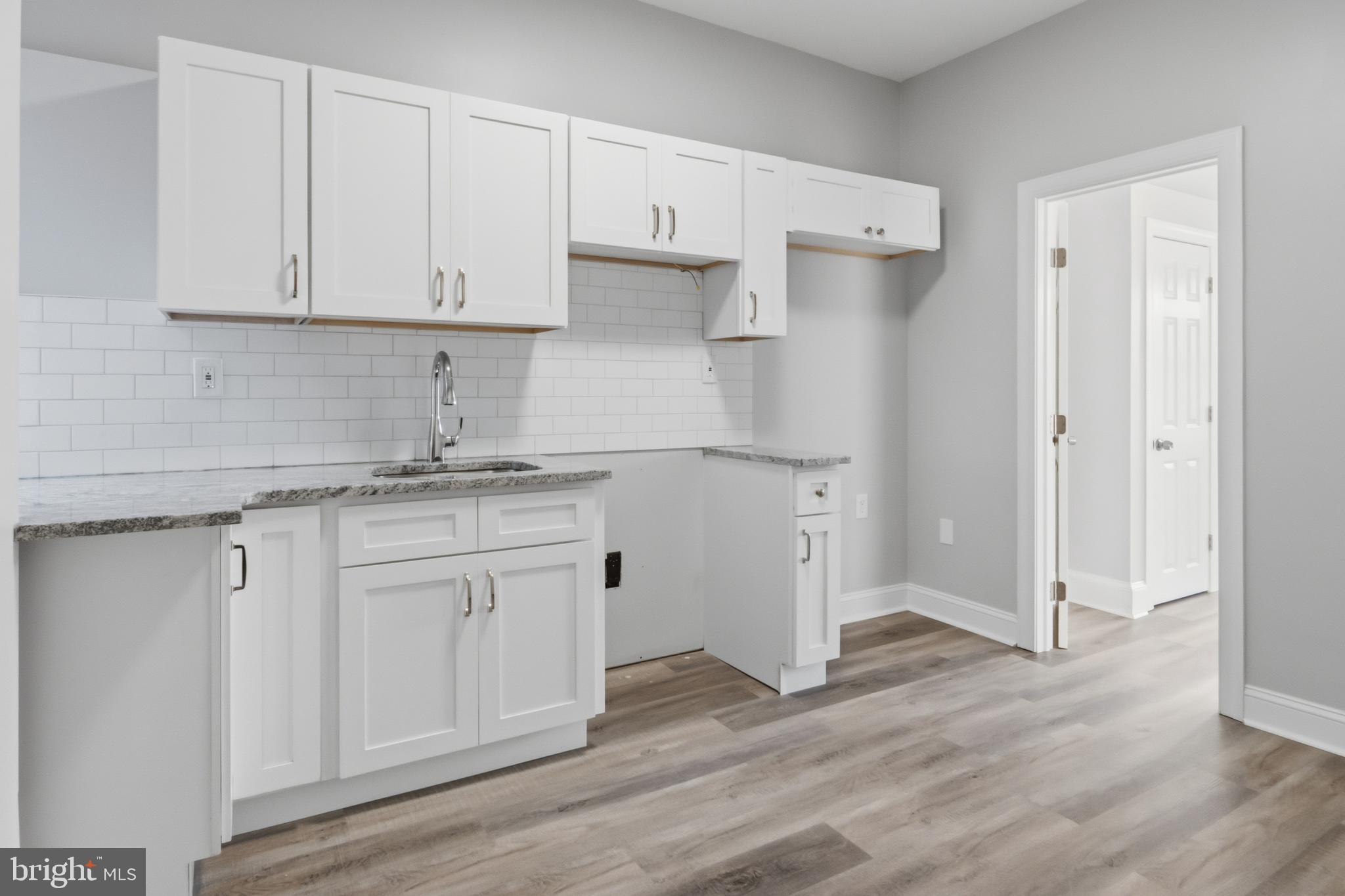 3545 North 11th Street, Unit 2F Philadelphia, PA 19140 - Photo 10 of 10 a kitchen with white cabinets and a sink