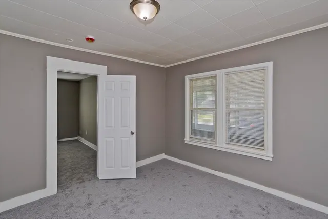 an empty room with windows and closet