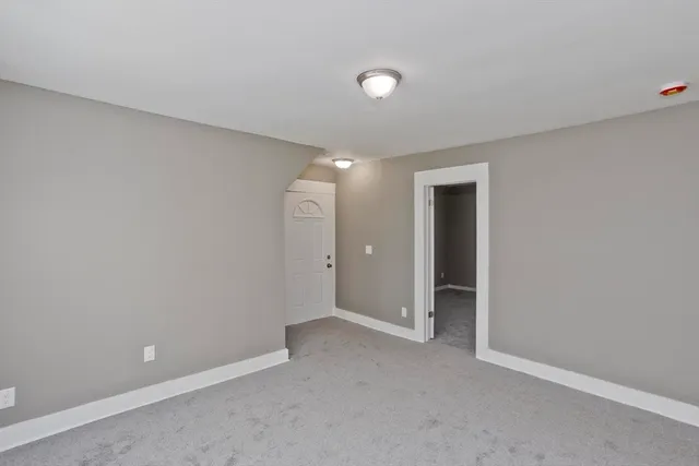 an empty room with closet area