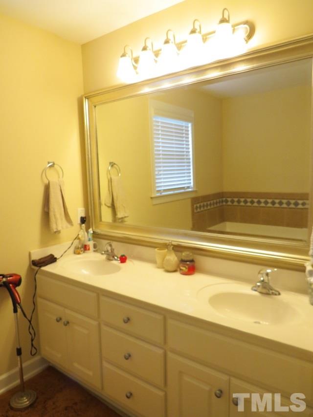 235 Steve Ridge Willow Spring, NC 27592 - Photo 12 of 25 a bathroom with a granite countertop sink and a mirror