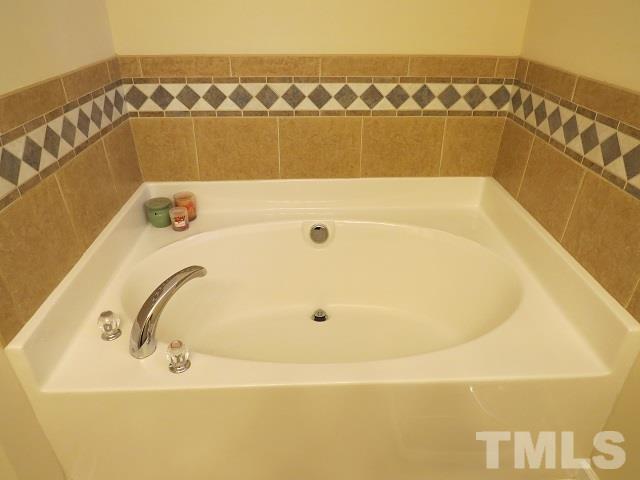 235 Steve Ridge Willow Spring, NC 27592 - Photo 13 of 25 a bathroom with a bathtub