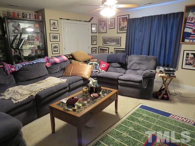 235 Steve Ridge Willow Spring, NC 27592 - Photo 17 of 25 a living room with furniture and a flat screen tv