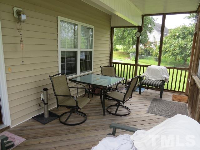 235 Steve Ridge Willow Spring, NC 27592 - Photo 19 of 25 a view of a porch with furniture and wooden floor