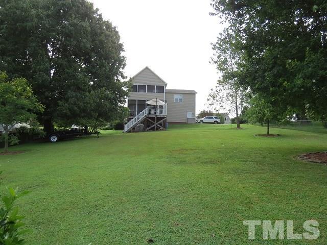 235 Steve Ridge Willow Spring, NC 27592 - Photo 22 of 25 a front view of a house with garden