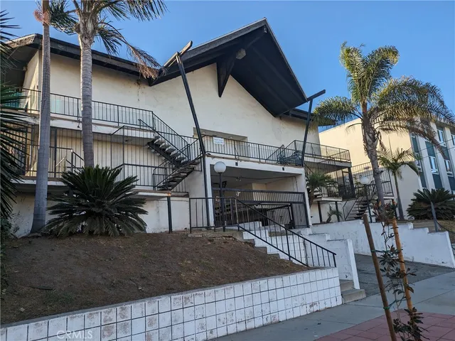 a view of house with outdoor space and sitting area
