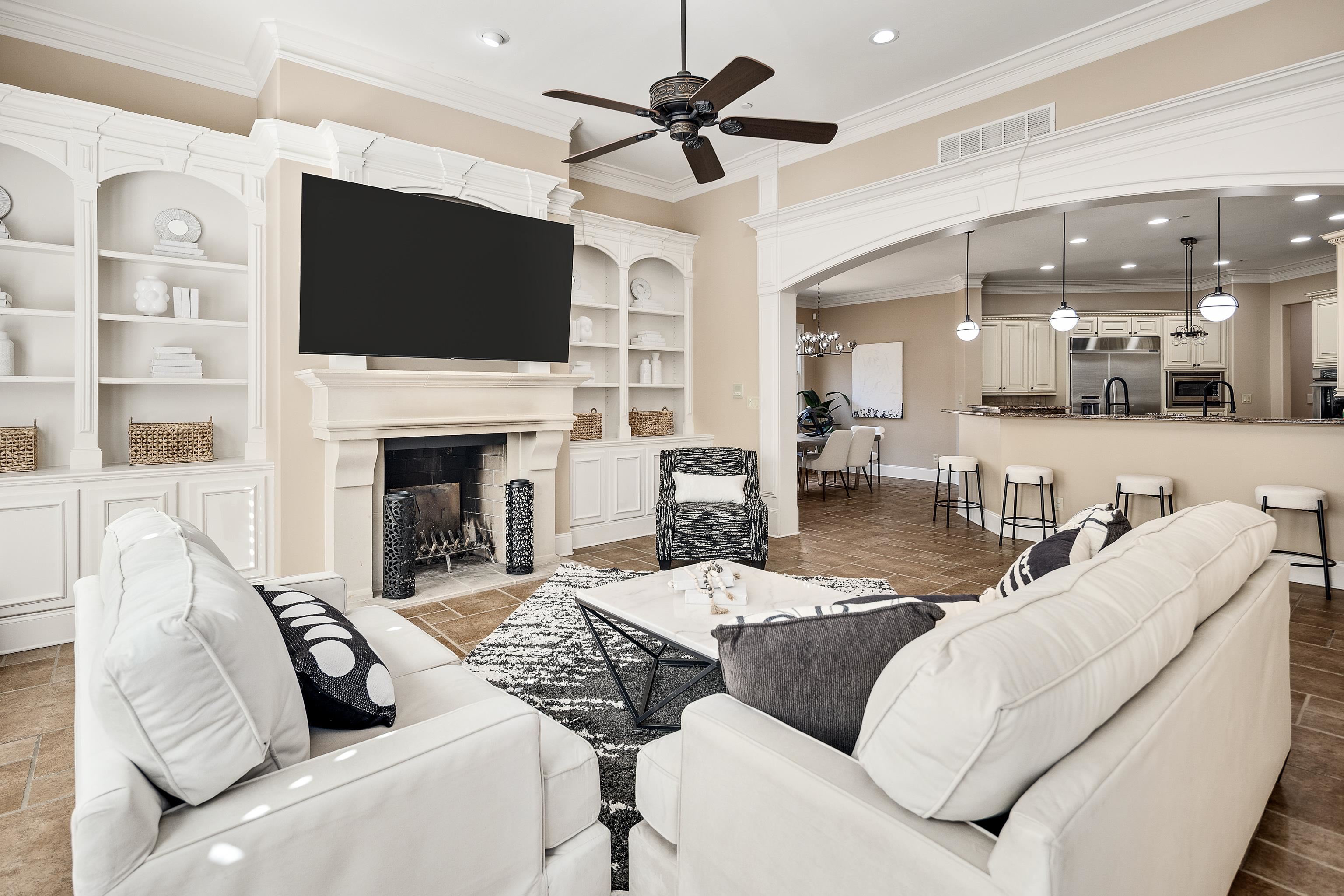 425 Buckland Cove Eads, TN 38028 - Photo 13 of 29 Living area featuring recessed lighting, ornamental molding, a fireplace with flush hearth, ceiling fan, and arched walkways