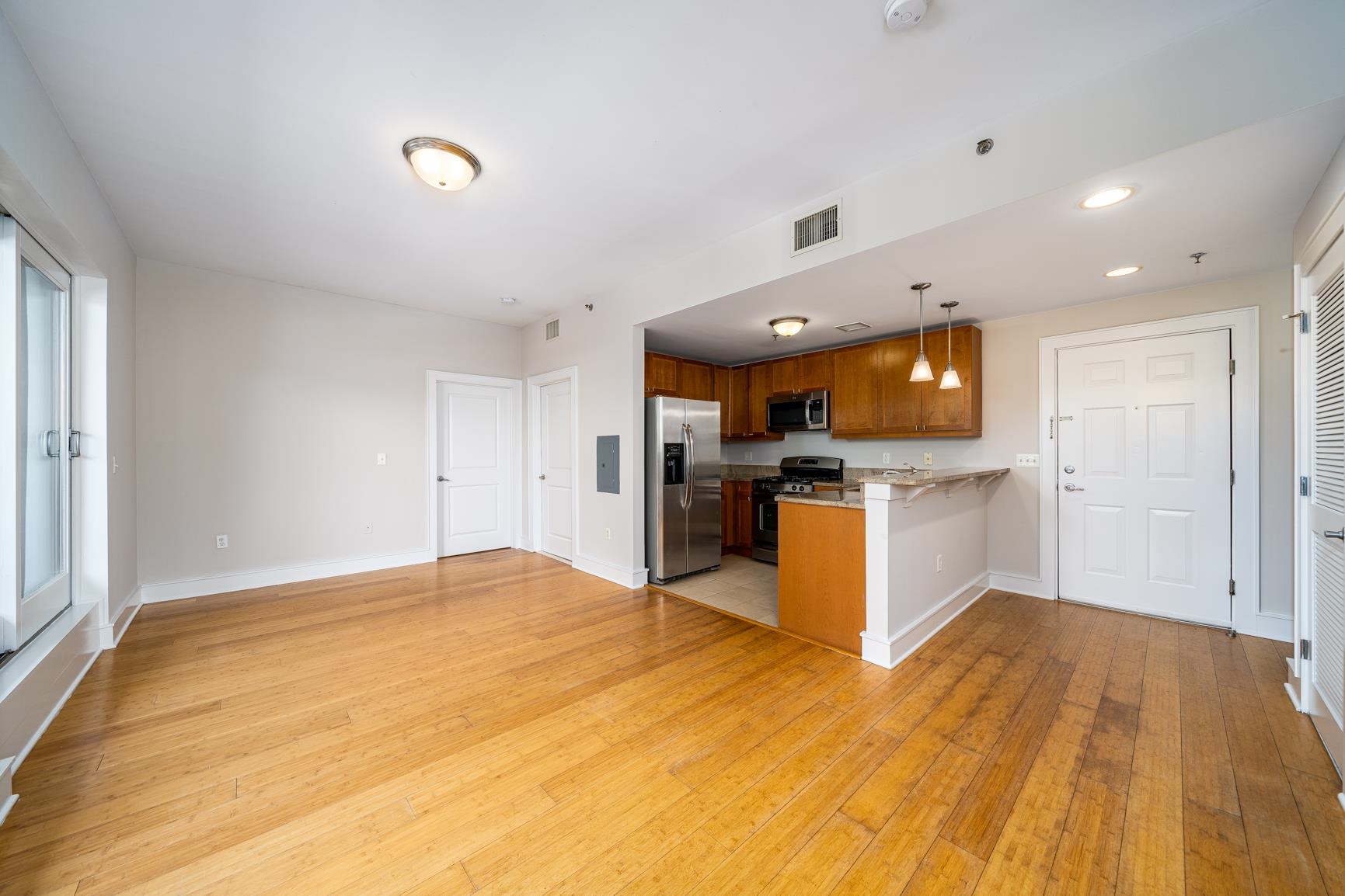 924 Jefferson Street, Unit 2A Hoboken, NJ 07030 - Photo 3 of 20 a kitchen with stainless steel appliances a stove top oven and cabinets
