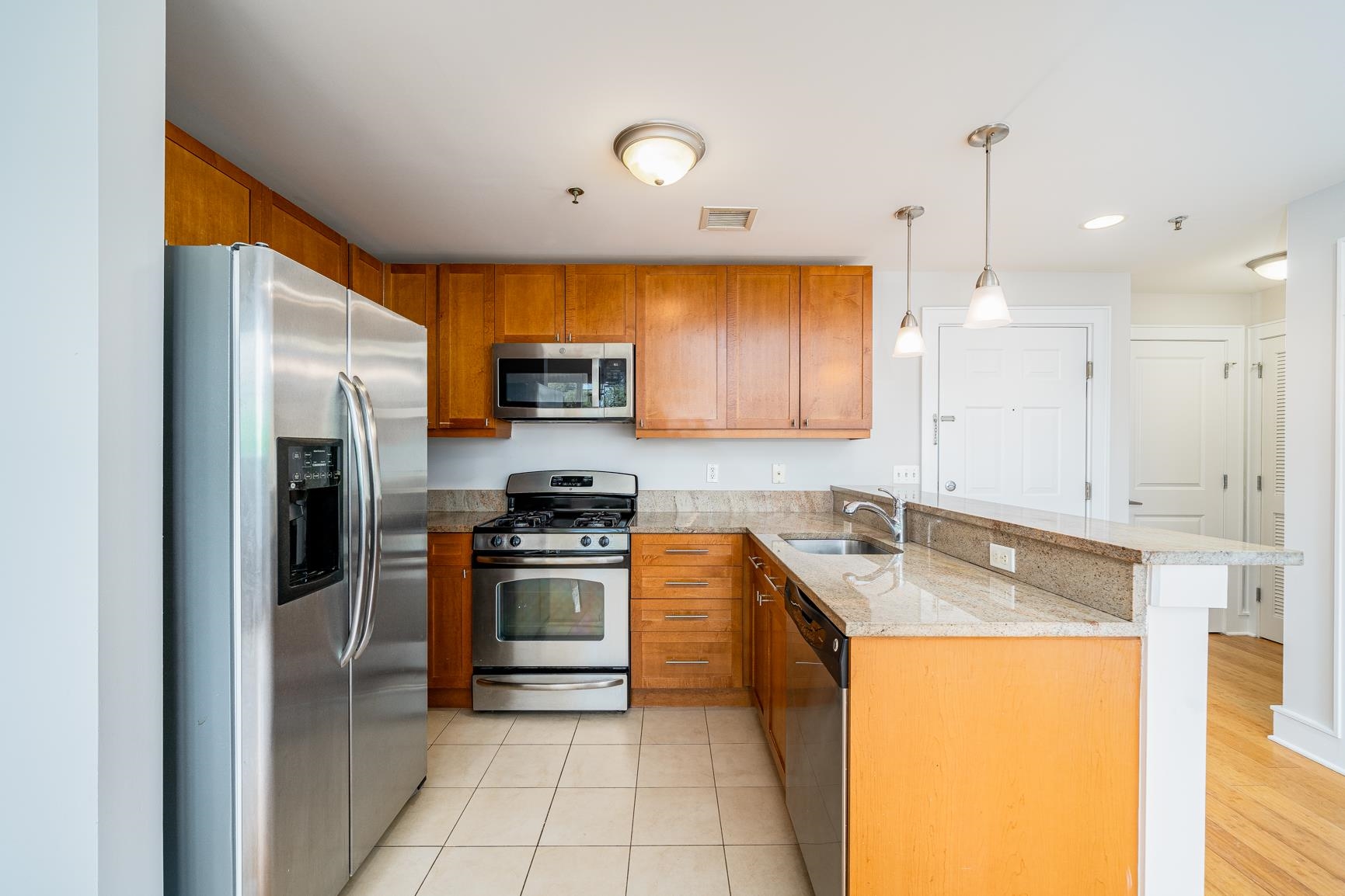 924 Jefferson Street, Unit 2A Hoboken, NJ 07030 - Photo 6 of 20 a kitchen with stainless steel appliances granite countertop a sink a stove and a refrigerator