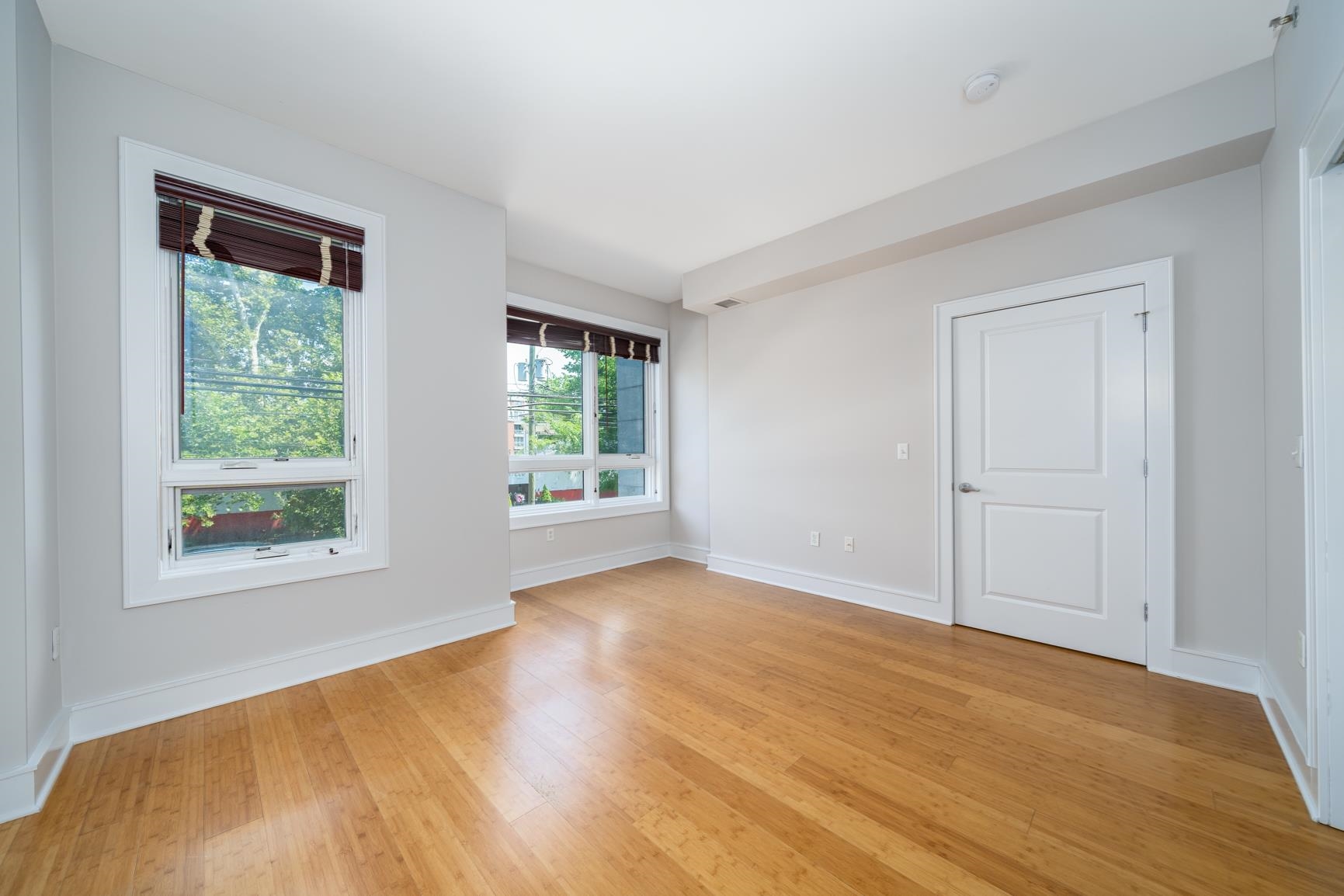 924 Jefferson Street, Unit 2A Hoboken, NJ 07030 - Photo 10 of 20 a view of an empty room with wooden floor and a window