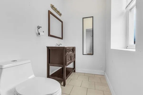 a white toilet sitting next to a bathroom sink