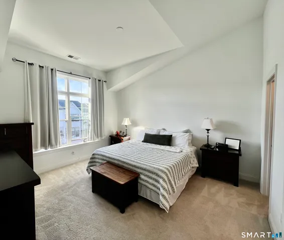 a bedroom with a bed and a television