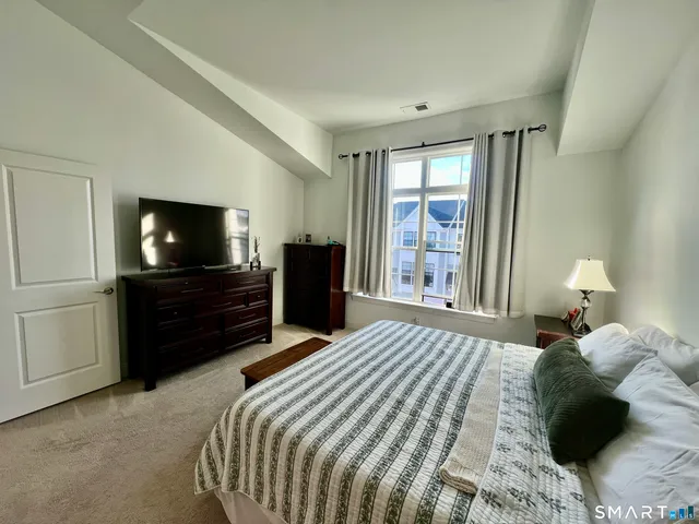 a bathroom with a sink mirror and toilet