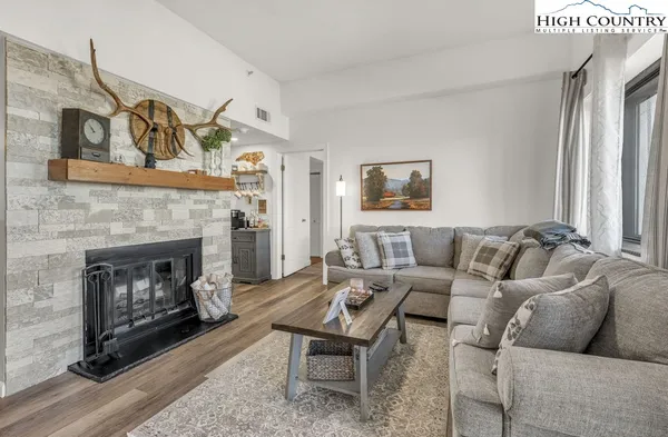 a living room with furniture and a fireplace