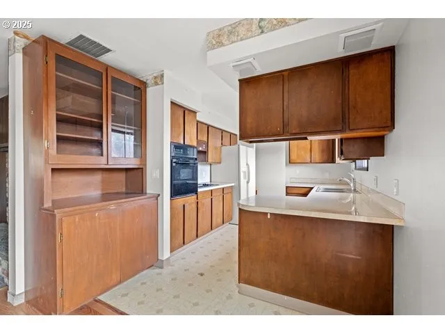a kitchen with stainless steel appliances granite countertop a sink and cabinets