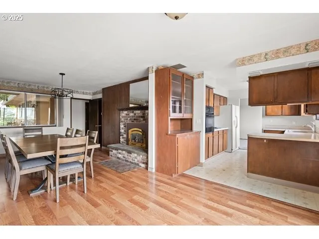 a dining room with furniture and a kitchen view