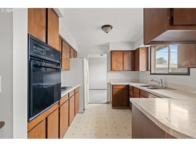 a kitchen with a sink stove and refrigerator
