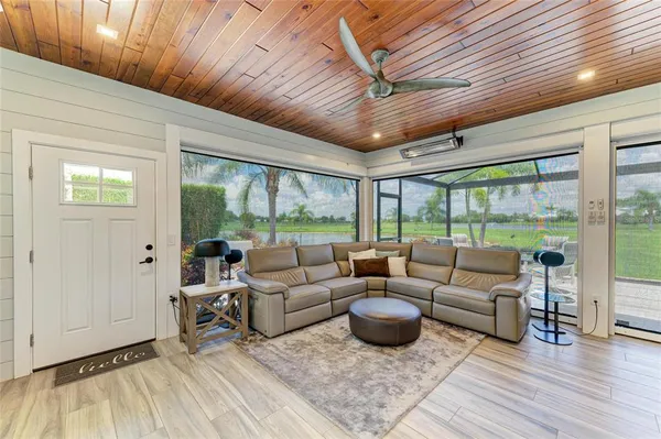 a living room with fireplace furniture and a floor to ceiling window