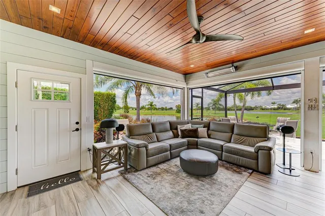 a kitchen with a table chairs microwave and cabinets