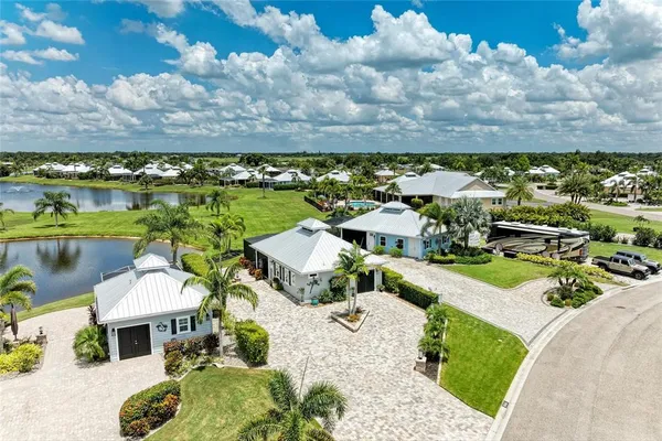 an aerial view of a house with yard swimming pool and outdoor seating