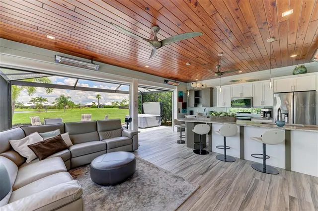 a kitchen with stainless steel appliances kitchen island granite countertop a stove and a refrigerator