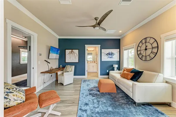 a view of a hallway with wooden floor and furniture