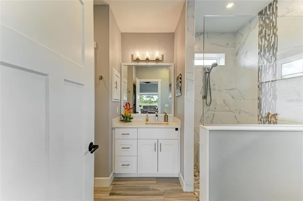 a view of a chairs and table in patio with a garden