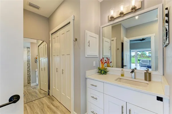 a body of water with a tree in the background