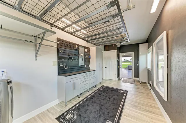 an aerial view of a house with a garden and lake view