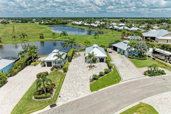 an aerial view of a house with a garden and lake view
