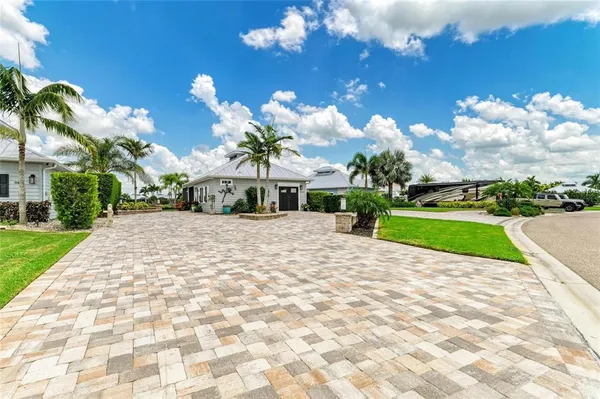 a view of a house with a yard and potted plants