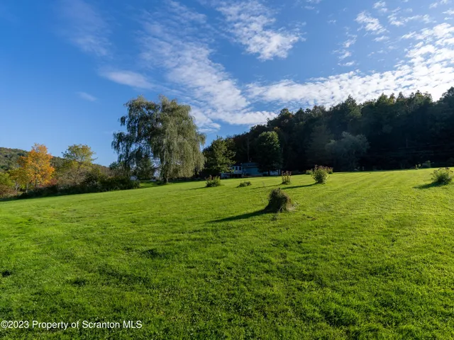 a view of building with grass and trees