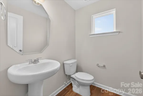 a bathroom with a sink toilet and a mirror