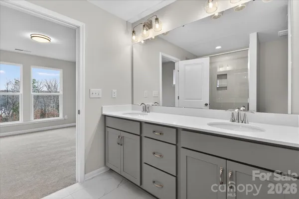 a bathroom with a double vanity sink and a mirror