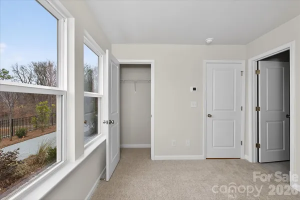 a view of an entryway with wooden floor and door