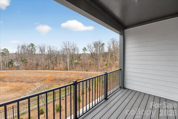 a view of a balcony with wooden floor and door