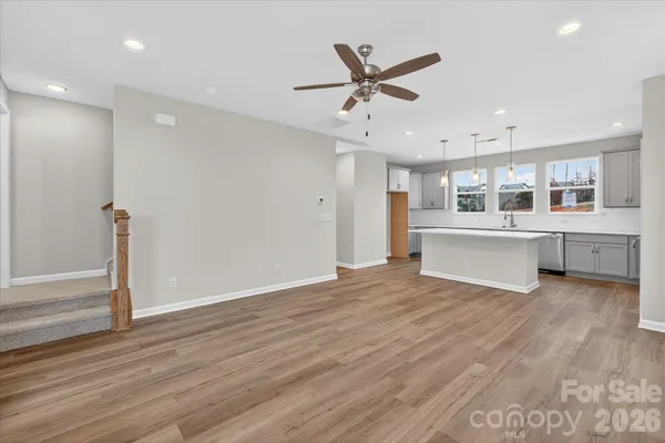 a view of a big room with wooden floor windows and entryway